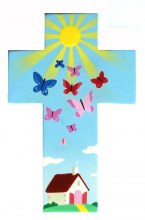 croix avec une église et des papillons volant vers le soleil 